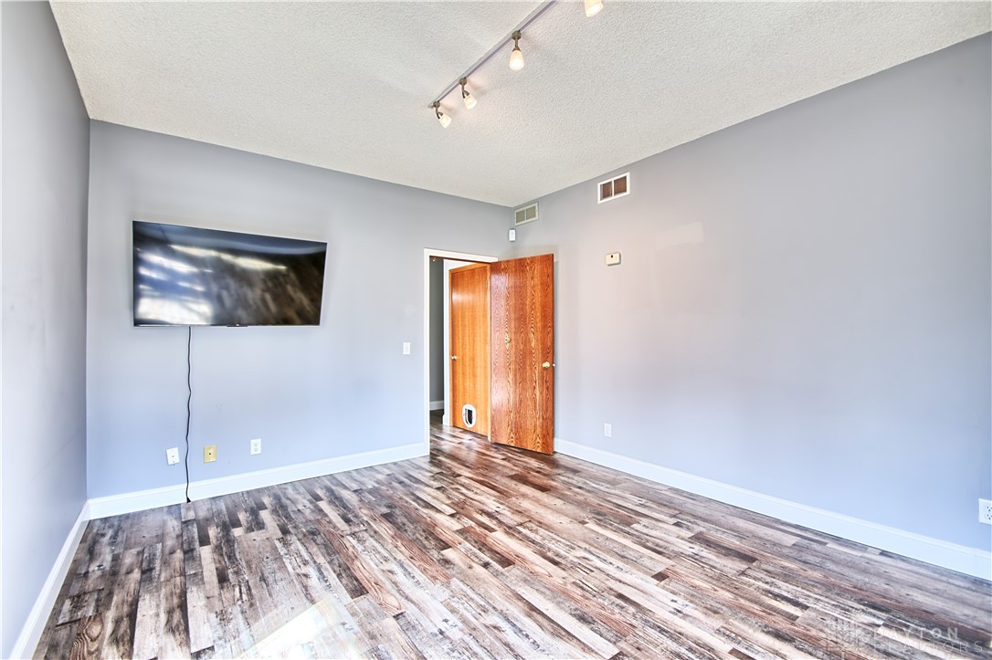 8711 Nicole Lane Springboro, OH 45066 - Photo 25 of 87 This flexible living area features durable flooring and track lighting.