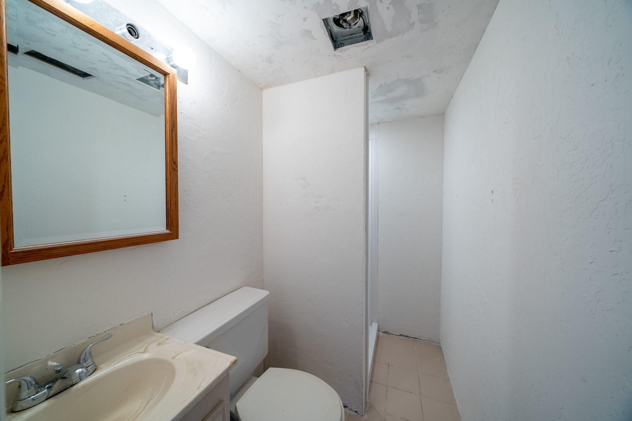 338 Ute Avenue Rifle, CO 81650 - Photo 11 of 14 a bathroom with a sink mirror and toilet