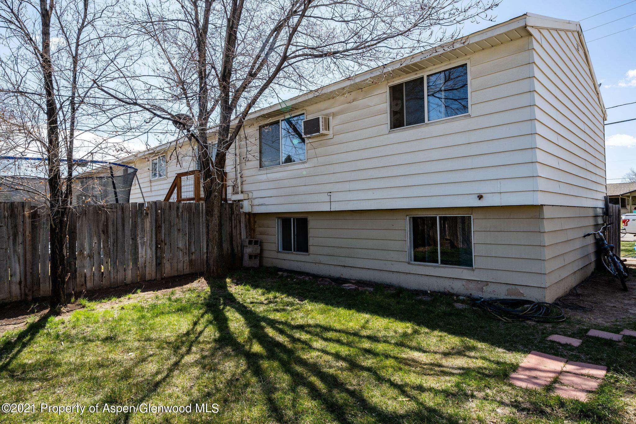 338 Ute Avenue Rifle, CO 81650 - Photo 2 of 14 a view of a backyard with a large tree