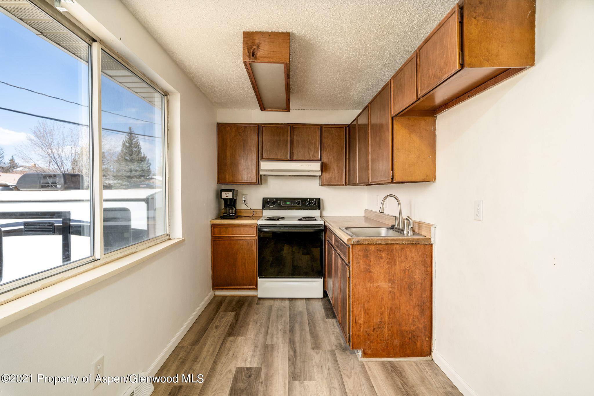 338 Ute Avenue Rifle, CO 81650 - Photo 6 of 14 a kitchen with a stove a sink and a microwave