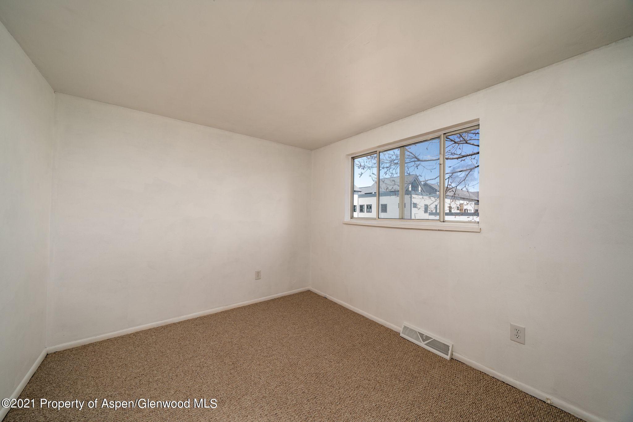 338 Ute Avenue Rifle, CO 81650 - Photo 7 of 14 an empty room with windows