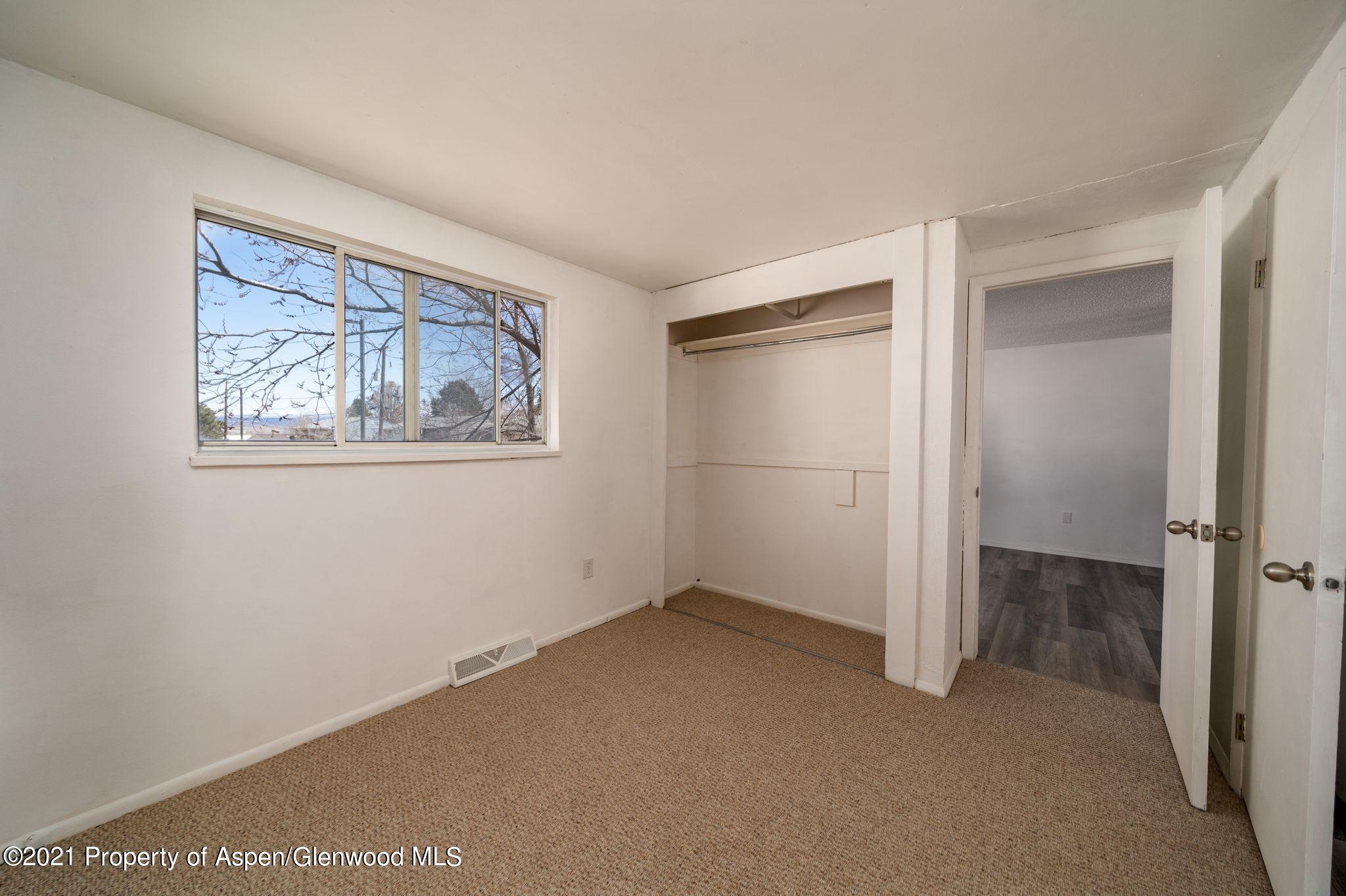 338 Ute Avenue Rifle, CO 81650 - Photo 8 of 14 a view of an empty room with a window