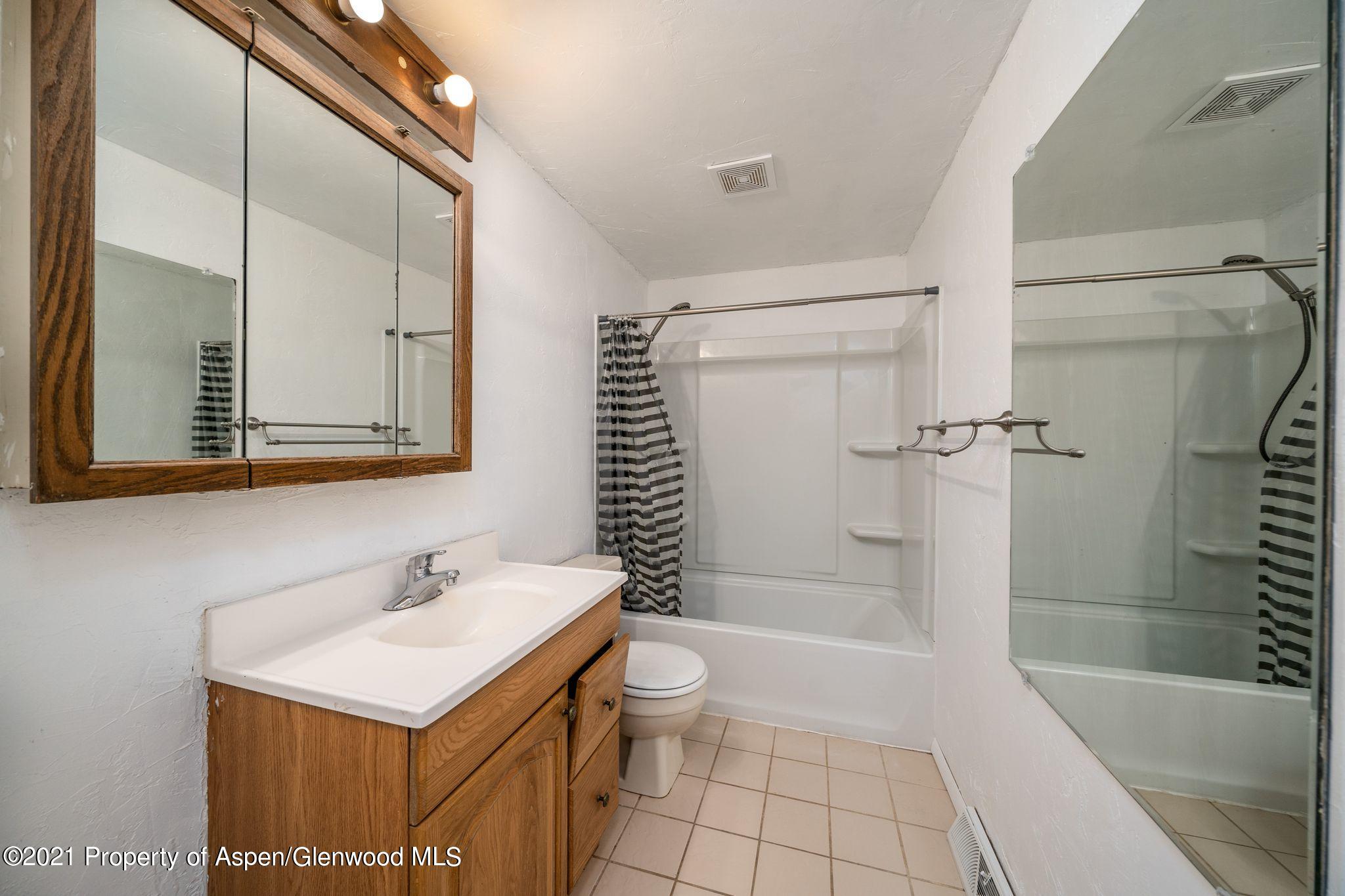 338 Ute Avenue Rifle, CO 81650 - Photo 9 of 14 a bathroom with a sink a toilet and shower