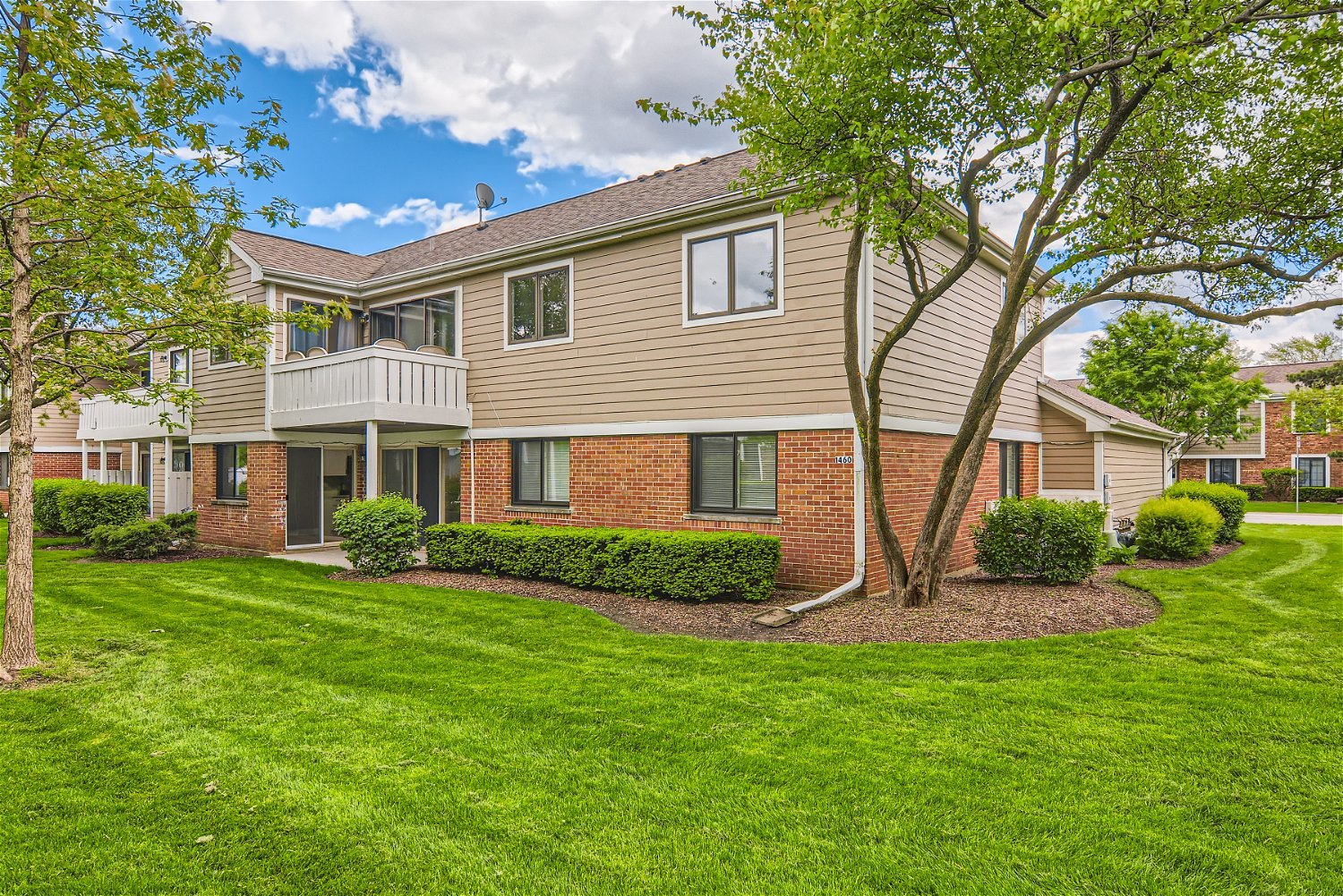1460 7 Pines Road, Unit A1 Schaumburg, IL 60193 - Photo 11 of 11 a view of a house with a yard and plants