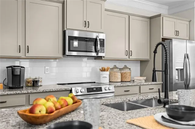 a open kitchen with stainless steel appliances granite countertop a sink a stove a refrigerator and island with wooden floor