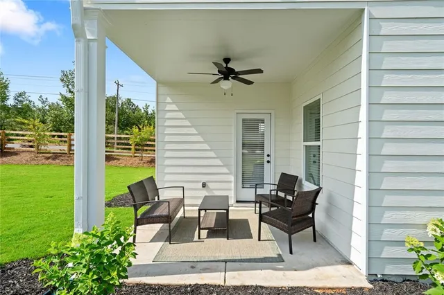 a balcony with furniture and a potted plant