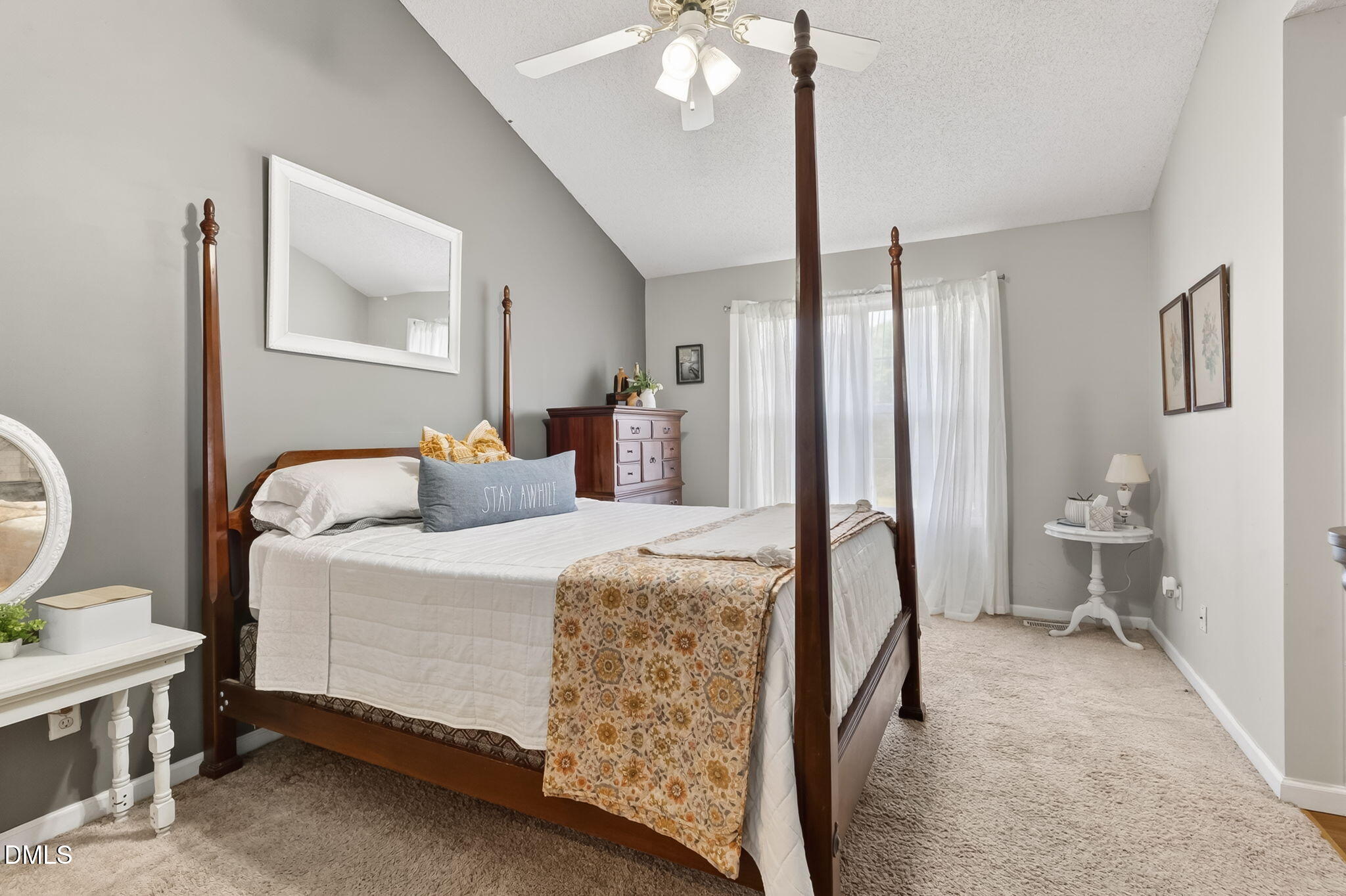 1101 Live Oak Road Coats, NC 27521 - Photo 12 of 29 a spacious bedroom with a bed and a chandelier