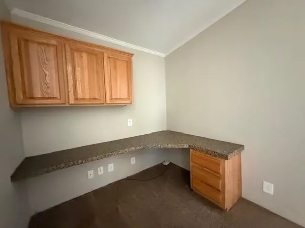 a room with wooden cabinets and a window