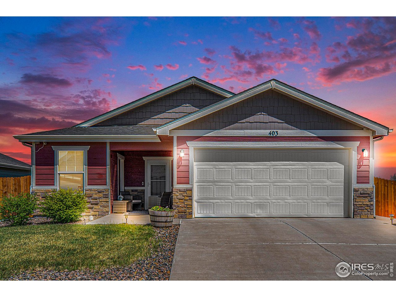 403 11th Avenue Wiggins, CO 80654 - Photo 2 of 13 a front view of a house with a yard and garage