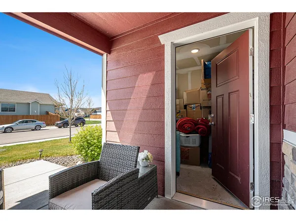 a kitchen that has a table chairs microwave and cabinets