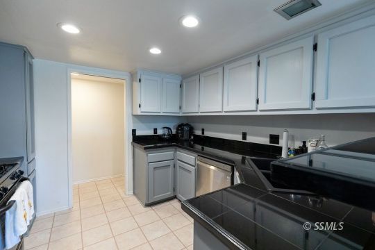 400 Tepatitlan Court Ridgecrest, CA 93555 - Photo 14 of 35 a kitchen with a sink and cabinets