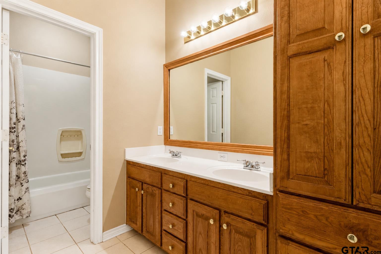 1388 Santa Fe Trail Tyler, TX 75703 - Photo 42 of 46 a bathroom with a shower sink and mirror