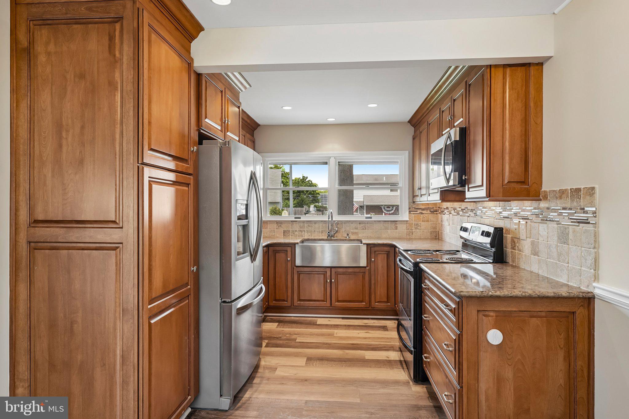 9 Rustleaf Lane Levittown, PA 19055 - Photo 29 of 45 Modern kitchen with rich wood tones.
