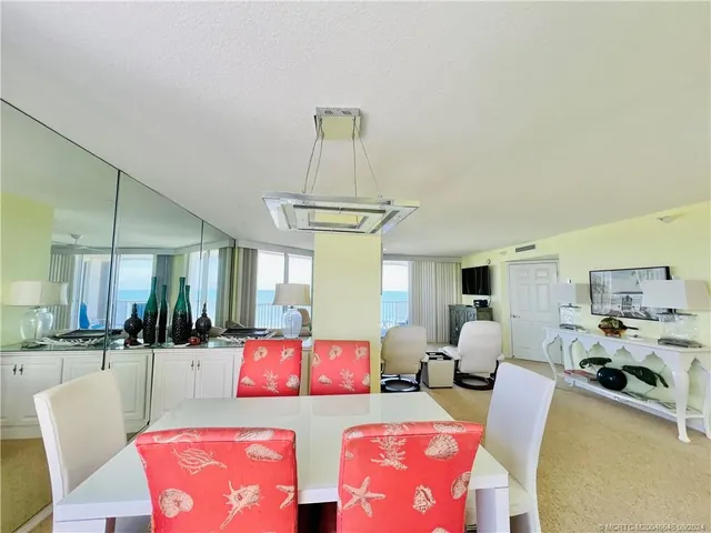 a living room with furniture and large windows