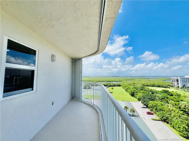 a view of a balcony with furniture