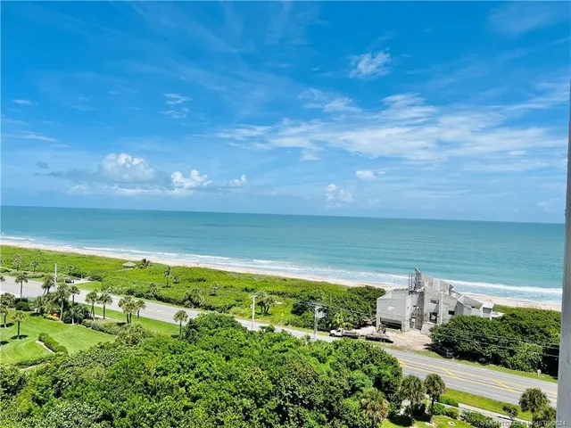 a view of a balcony with chair and the potted plant