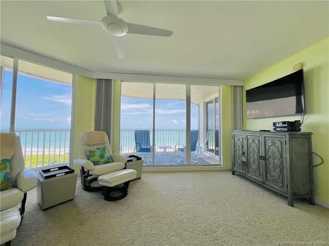 a bedroom with a bed and a flat tv screen on the dresser