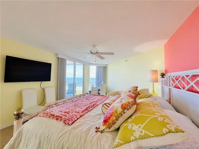 a view of a balcony with wooden floor & fence