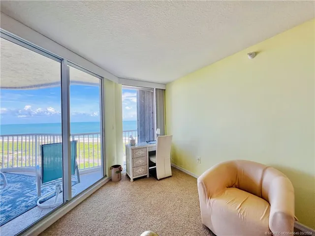 a view of a balcony with potted plants