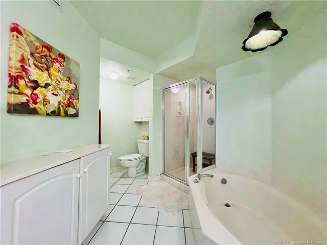 a living room with patio furniture and a flat screen tv