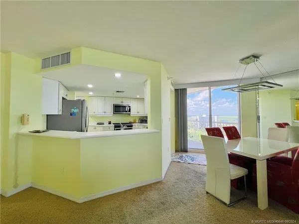 a dining room with furniture and window