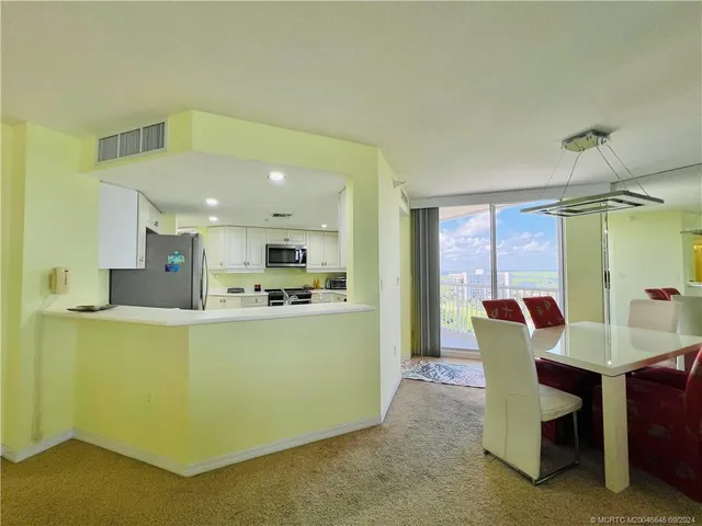 a dining room with furniture and window