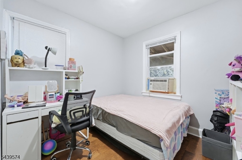 328 John Street Elizabeth, NJ 07202 - Photo 7 of 9 a bedroom with a bed and a window
