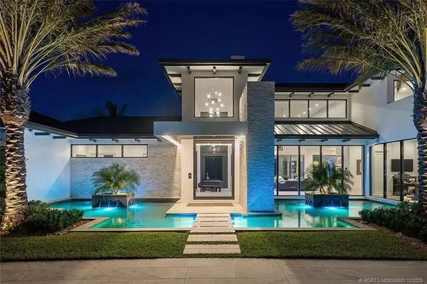 a front view of a house with a garden
