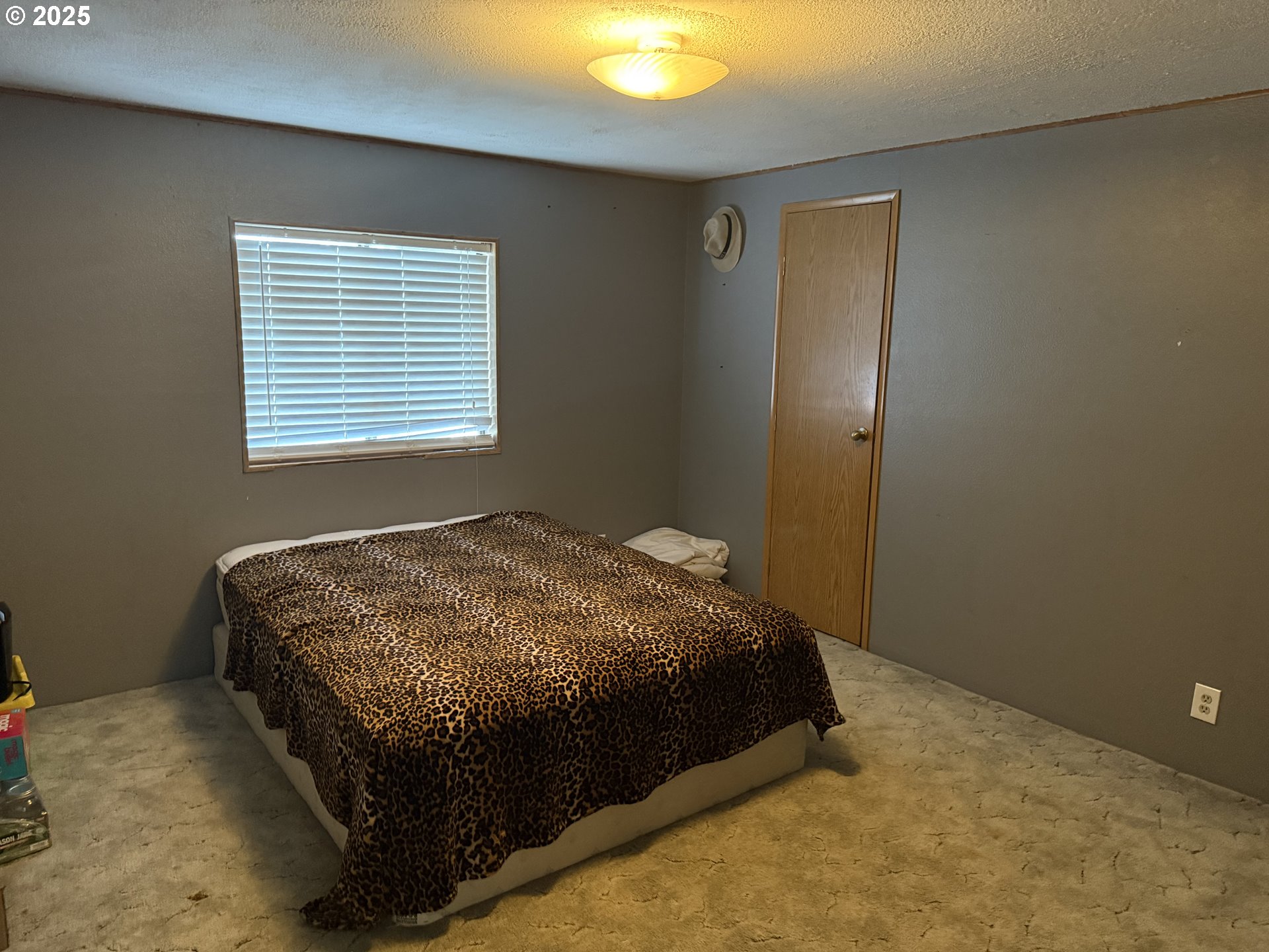 590 Northeast Spring Street White Salmon, WA 98672 - Photo 13 of 13 a bed sitting in a bedroom next to a window