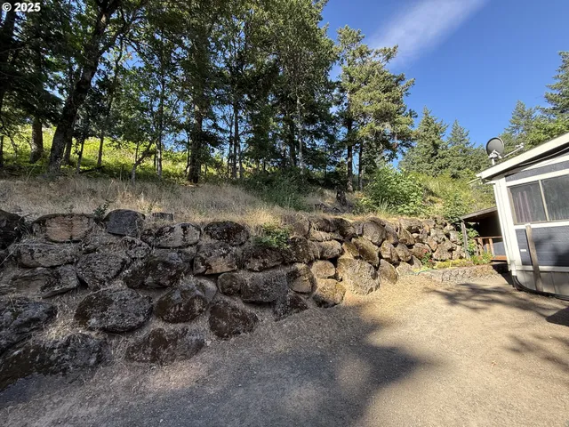 a backyard of a house with table and chairs