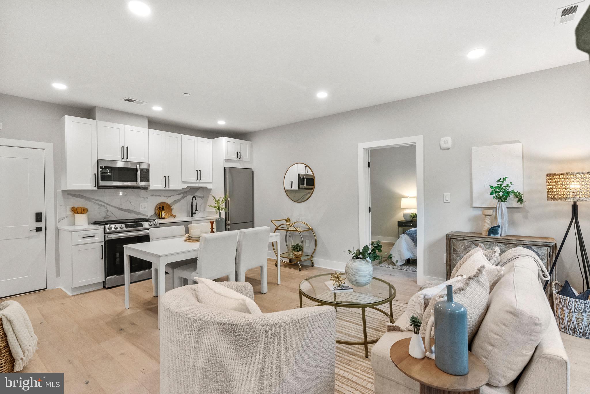 2019 M Street Northeast, Unit 1 Washington, DC 20002 - Photo 9 of 31 a living room with furniture kitchen view and a wooden floor
