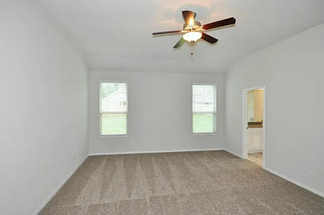 a kitchen with stainless steel appliances granite countertop a stove top oven a sink dishwasher a refrigerator and white cabinets with wooden floor