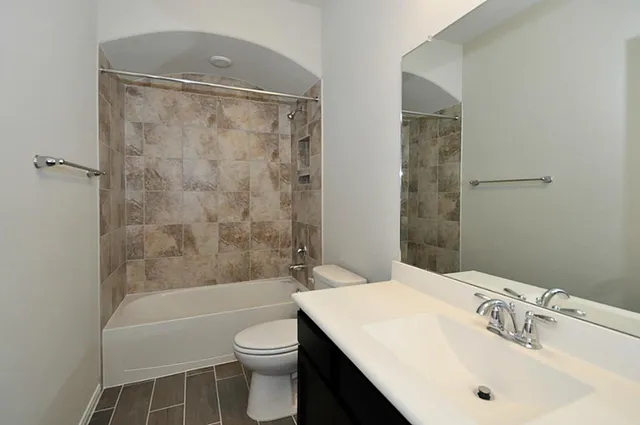 a bathroom with a sink toilet and shower