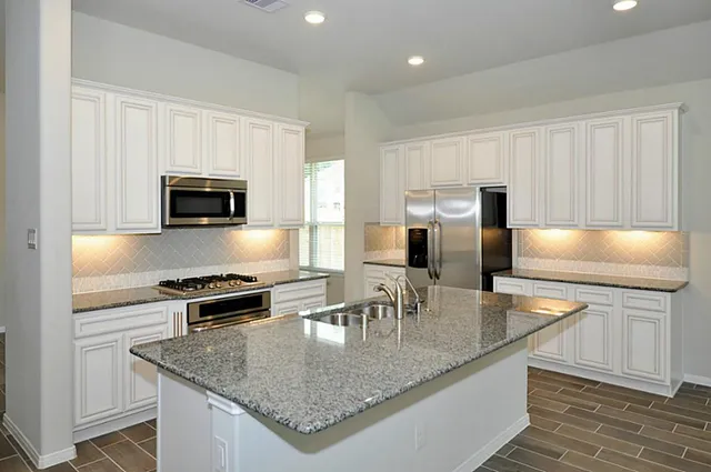 an empty room with windows and a fireplace