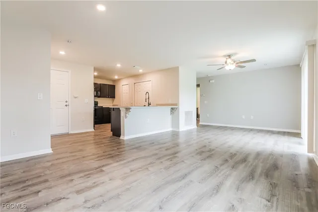 a view of a kitchen with a kitchen island wooden floor and a refrigerator