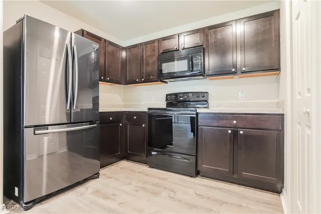 a kitchen with granite countertop stainless steel appliances and wooden cabinets