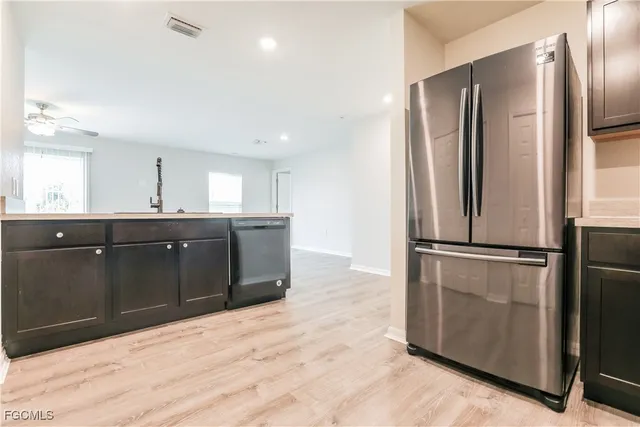a kitchen with stainless steel appliances granite countertop a refrigerator and a sink