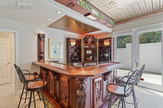 8 Pine Road Colorado Springs, CO 80906 - Photo 7 of 19 Bar with wood counters and light carpet