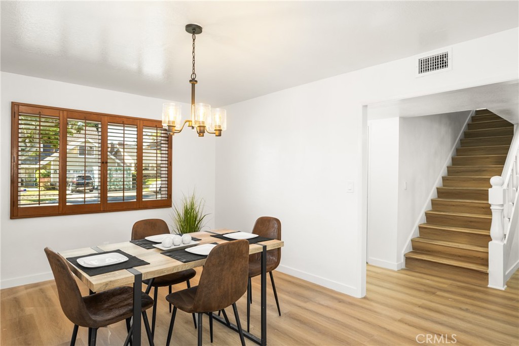 19212 Gunlock Avenue Carson, CA 90746 - Photo 22 of 56 a view of a dining room with furniture window and wooden floor