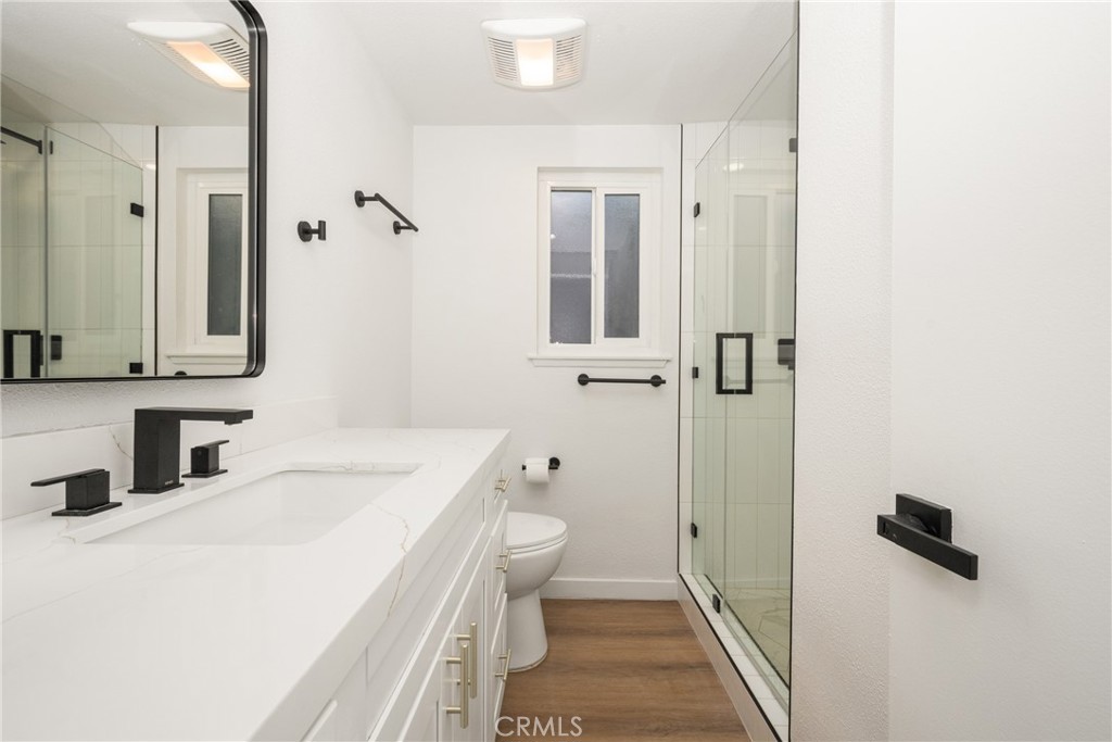 19212 Gunlock Avenue Carson, CA 90746 - Photo 35 of 56 a bathroom with a sink a toilet a mirror and shower