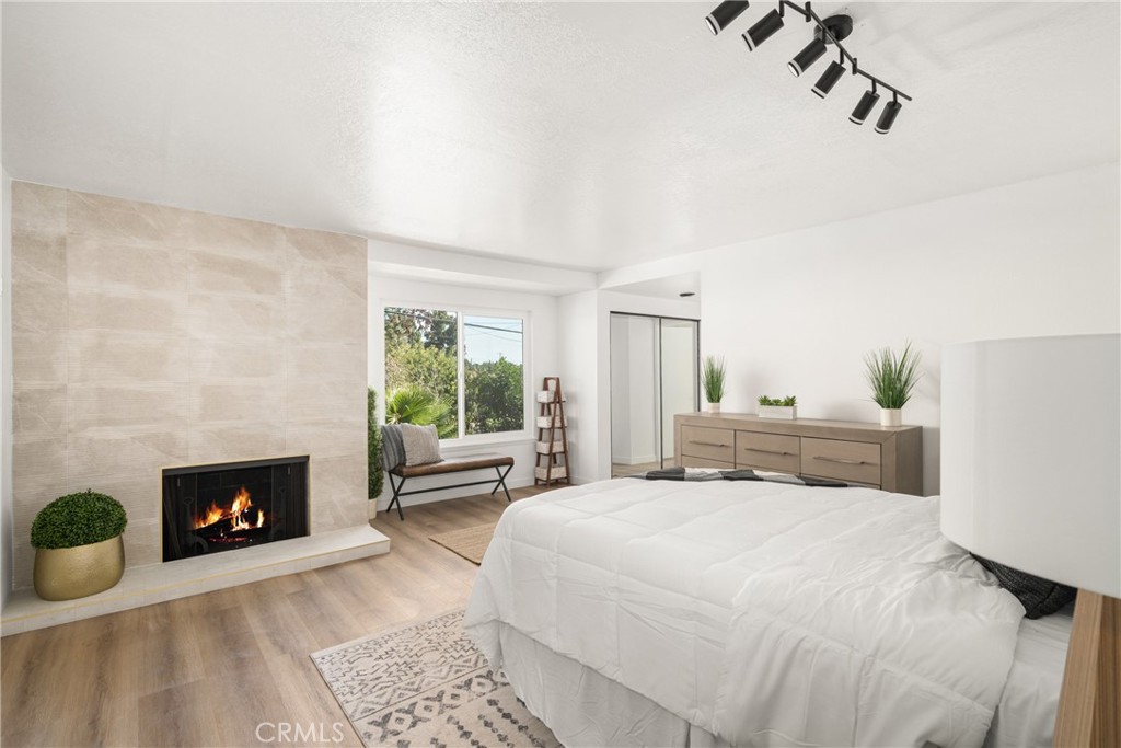 19212 Gunlock Avenue Carson, CA 90746 - Photo 40 of 56 a bedroom with a bed and a fireplace