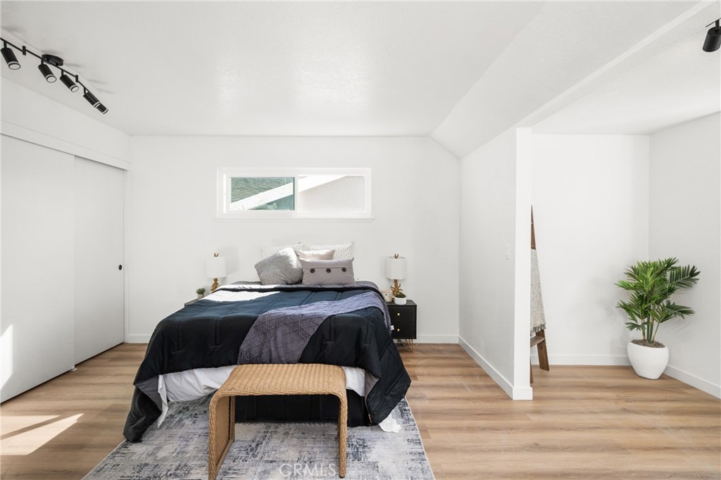 19212 Gunlock Avenue Carson, CA 90746 - Photo 54 of 56 a bedroom with a bed and wooden floor