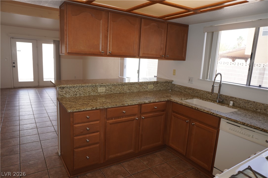 8328 Del Rey Avenue Las Vegas, NV 89117 - Photo 11 of 38 A well-appointed kitchen showcasing durable granite counters and a bright window overlooking the outdoors.