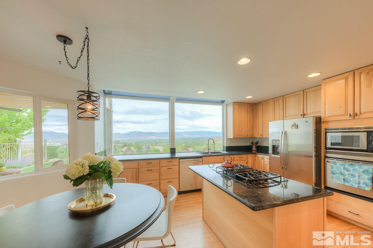 2688 Starr Meadows Loop Reno, NV 89519 - Photo 6 of 27 a kitchen with a stove a sink and a refrigerator