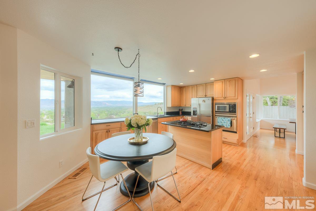 2688 Starr Meadows Loop Reno, NV 89519 - Photo 7 of 27 a living room with dining table and a wooden floor