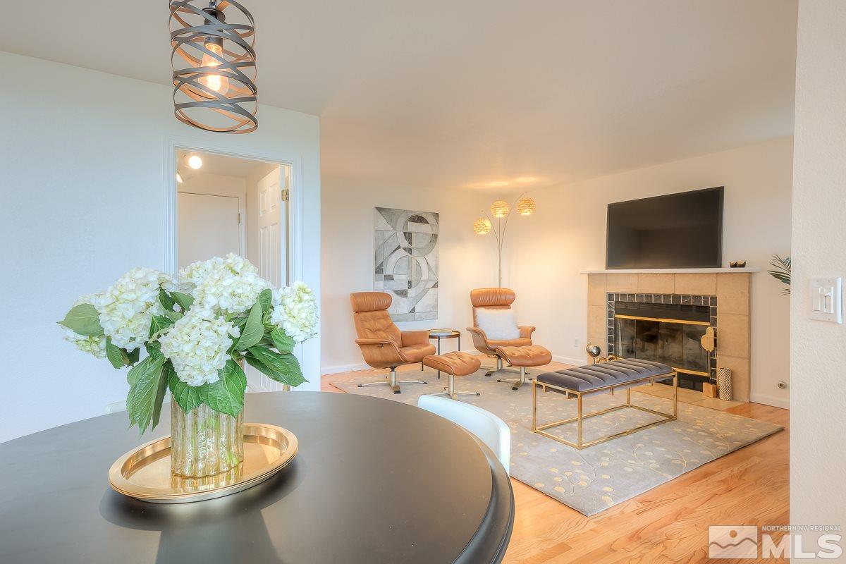 2688 Starr Meadows Loop Reno, NV 89519 - Photo 8 of 27 a living room with fireplace furniture and a chandelier