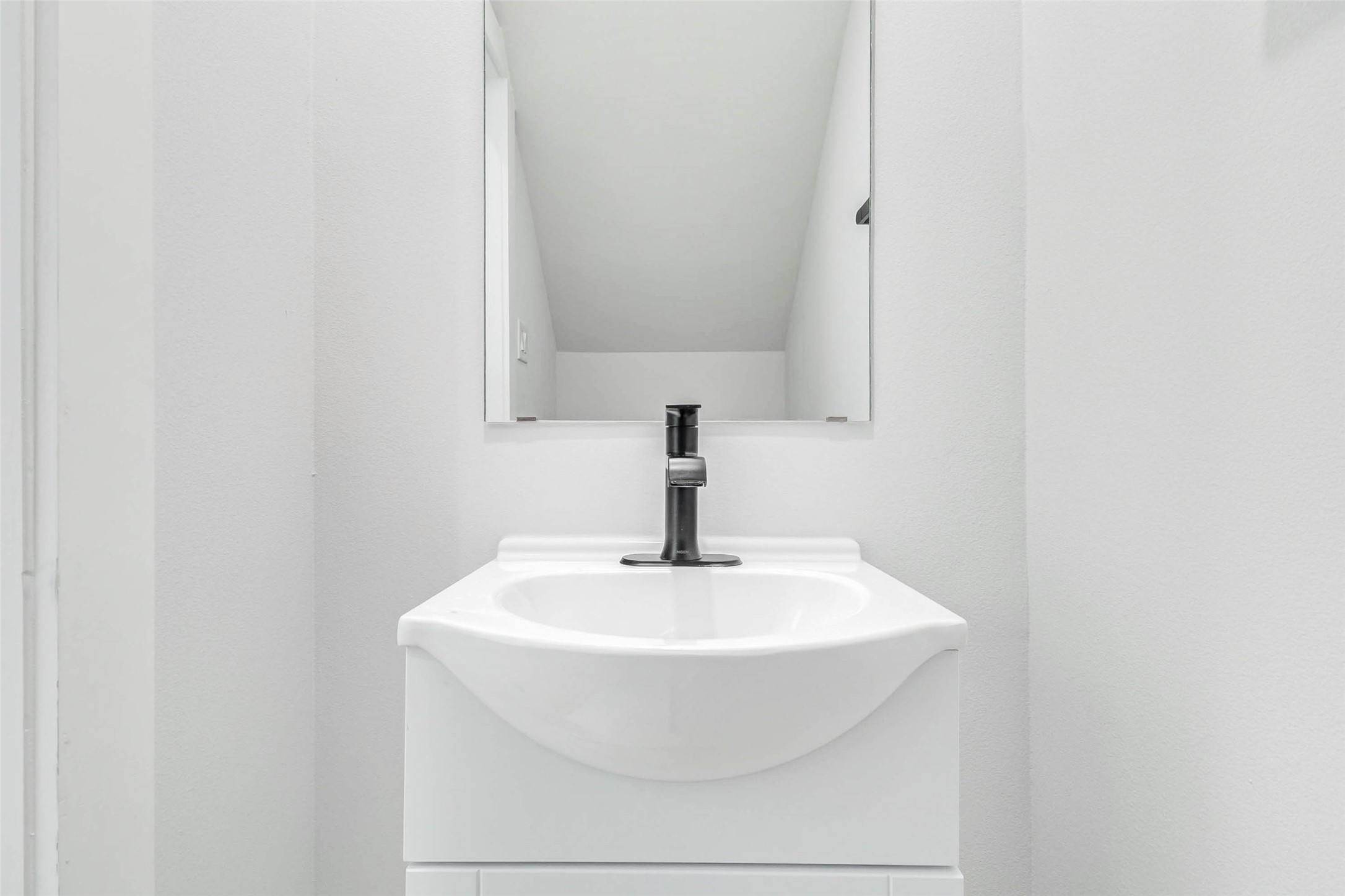 2310 Campbell Road, Unit C Houston, TX 77080 - Photo 22 of 27 a bathroom with a sink and a mirror