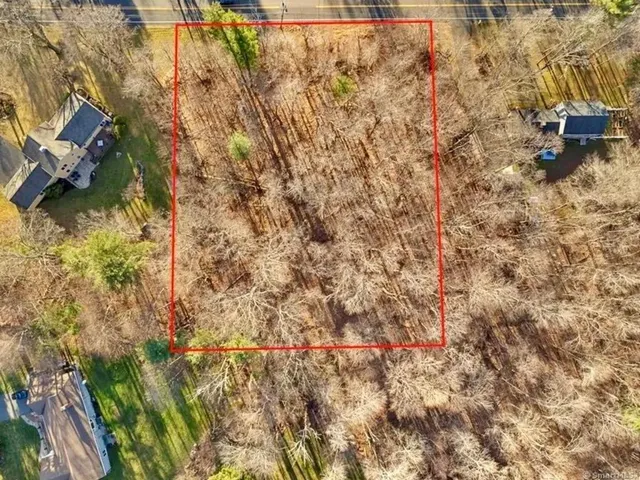 a backyard of a building with large trees