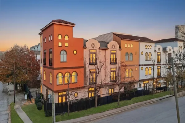 a front view of a residential apartment building with a yard