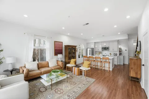 a living room with furniture and wooden floor